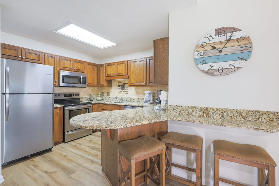 Kitchen with three barstools