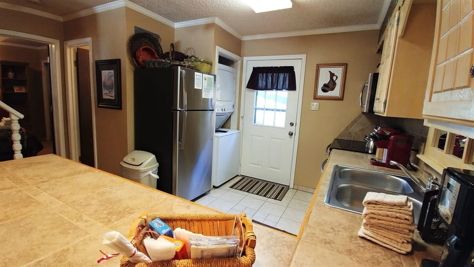 You'll love preparing meals in this fully-equipped kitchen, complete with modern appliances, ample counter space, and all the essentials you need for a comfortable, home-cooked experience during your stay.