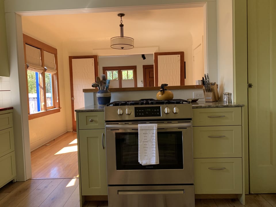 View from the kitchen into the dining room, living room and onto the patios.