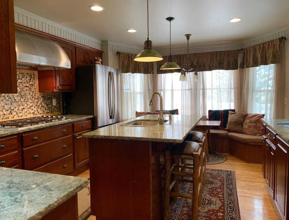 KITCHEN with bow window and seating.