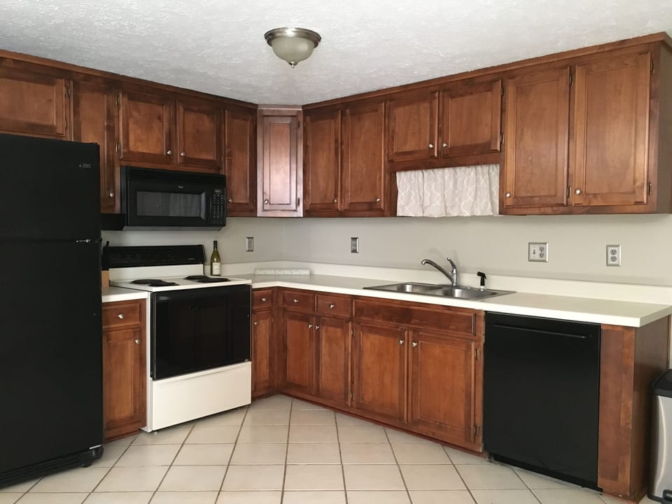 kitchen with full size refrigerator, range, microwave, and  dishwasher