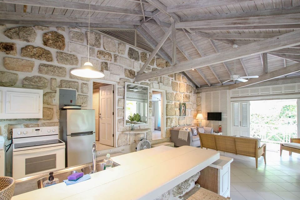 The open plan living area and kitchen open up to a wrap around patio