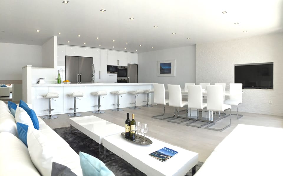Another View of living/dining/kitchen area. Plenty of seating with 6 barstools.