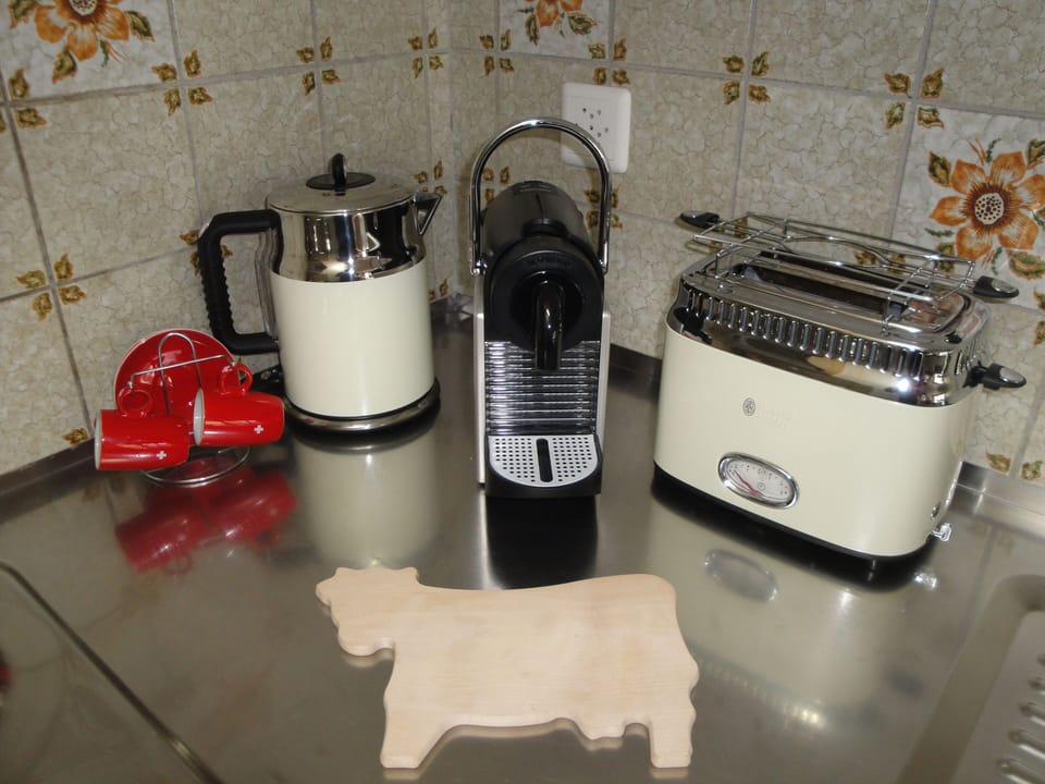There is an electric kettle, a Nespresso machine, as well as a toaster.
