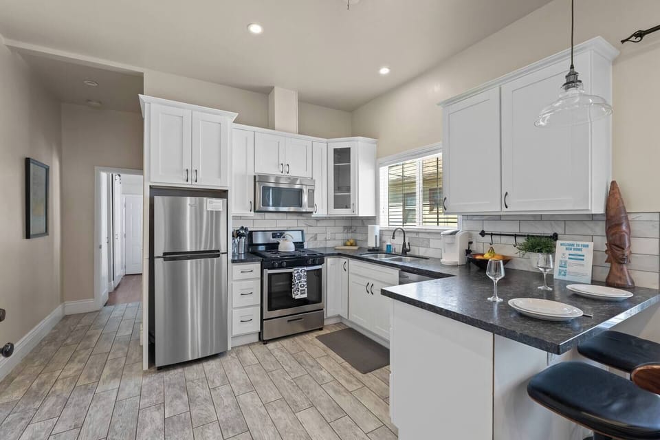 A full-sized kitchen equipped with all the essentials to prepare a delicious home-cooked meal, including pots, pans, olive oil, salt, pepper, and more.