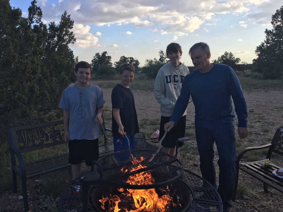 Watching sunset while grilling at fire pit 