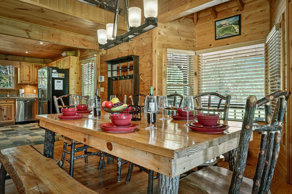 At this pet-friendly cabin rental in Blue Ridge, the custom wood table is the heart of the home, ideal for cozy meals or card games with the kids