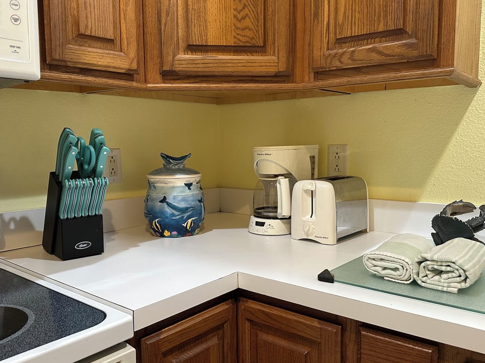Full kitchen with coffee maker, toaster, blender, stove, oven and dishwasher.