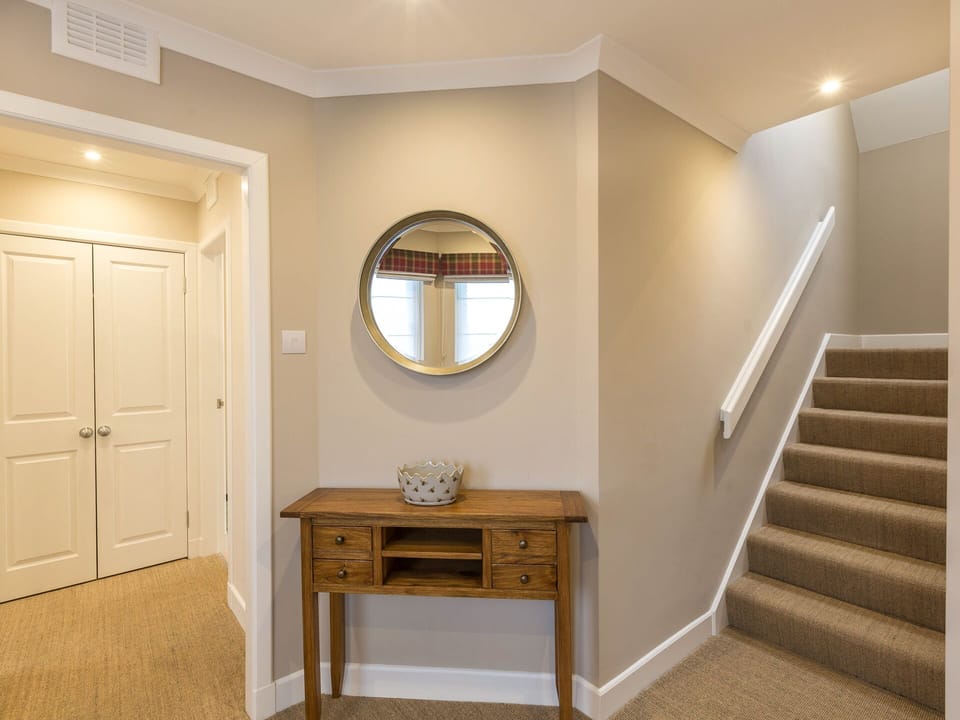 Hall leading to 2 twin bedded ensuite bedrooms, stairs leading to lounge/dining.