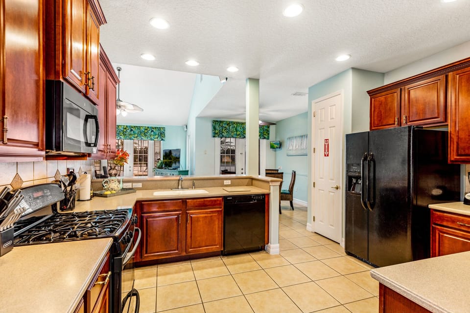 spacious well equipped kitchen open to living room