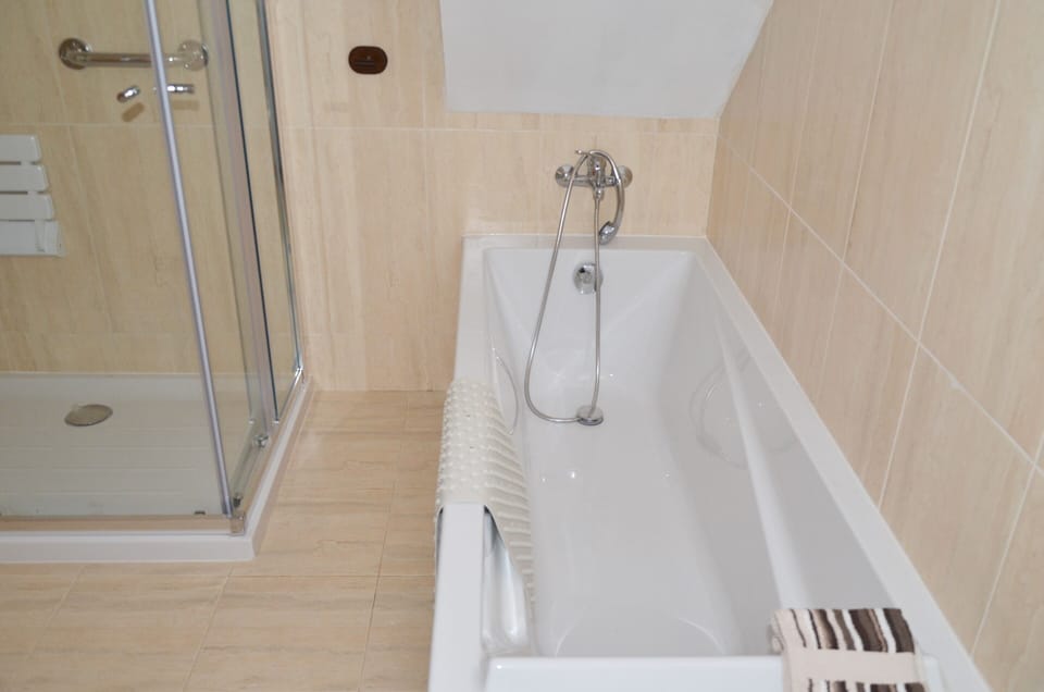 Groundfloor bathroom, large bath,walk in shower with hand rails and shower seat.