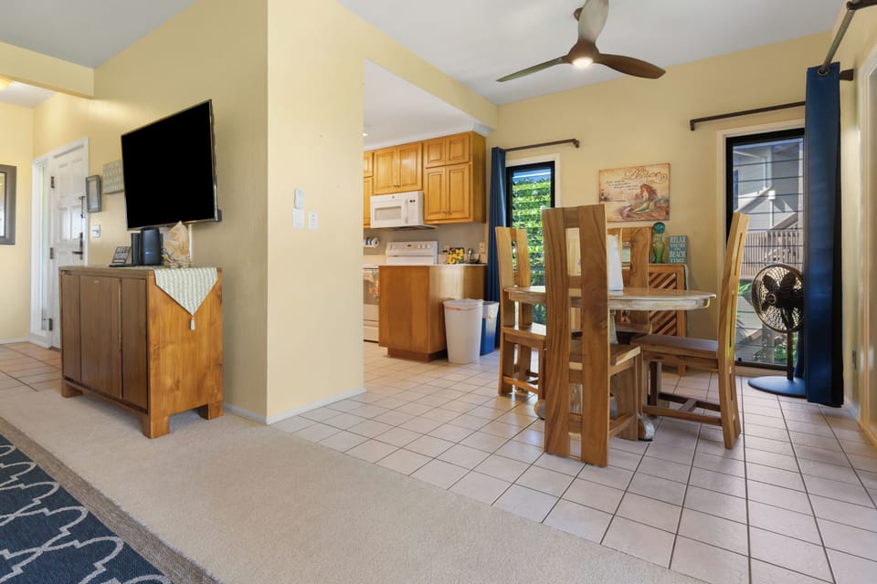 Dining room. Large screen smart TV in living room.