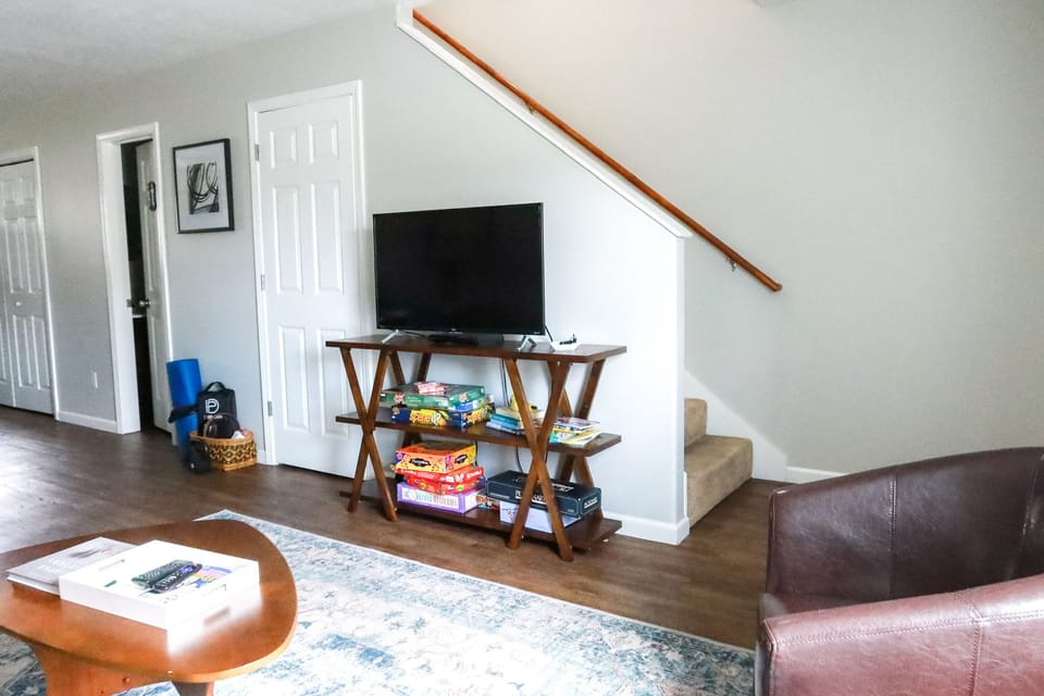 Spacious living room with tv, games, and cards.