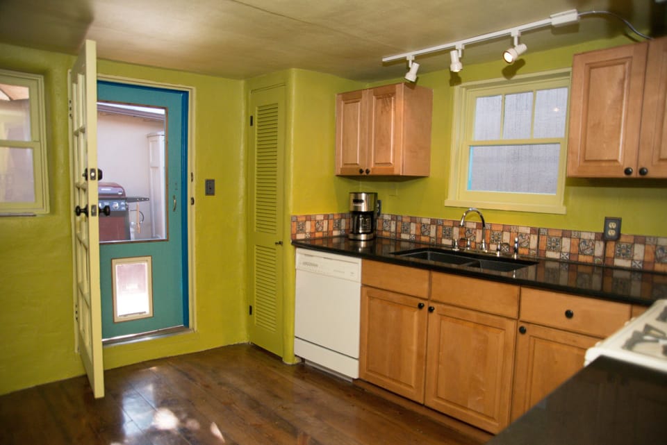 Kitchen with door leading to enclosed back patio area