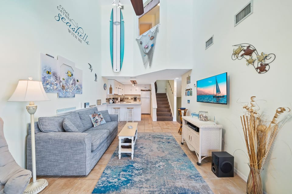 Window opening in master suite hallway offers view of the living area below.