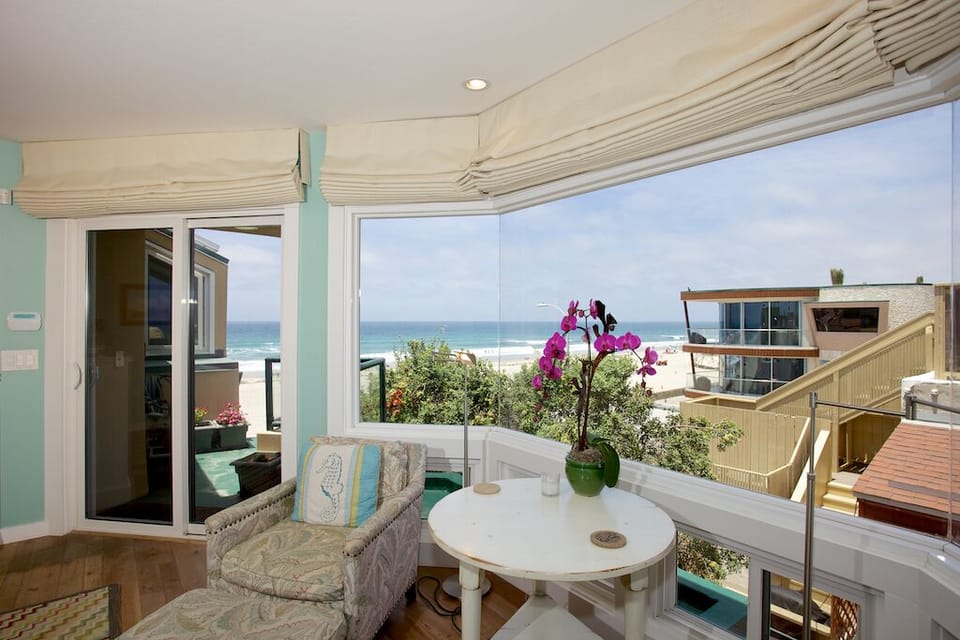 Master Bedroom suite with sitting area and views of the ocean with private deck.