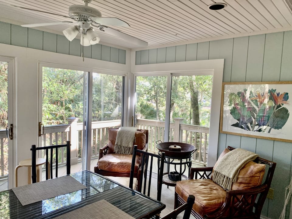 Beautiful sunroom with table and lounge chairs 