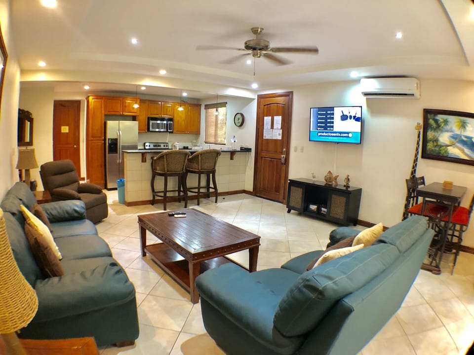Large living room with cable tv, a/c, fan, and direct access to the terrace.