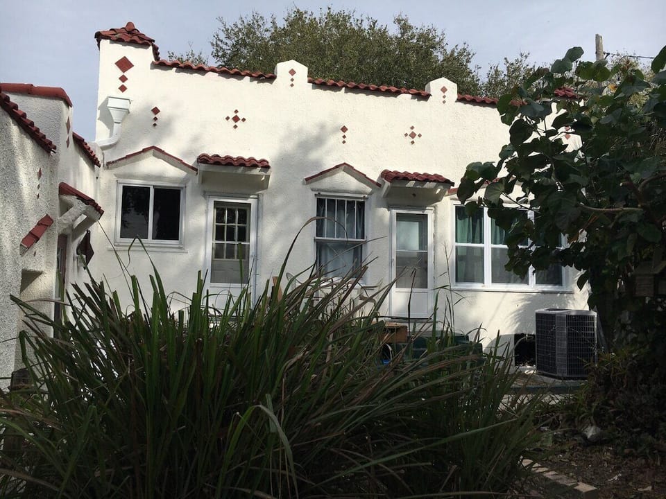 Back of house where entrance to unit is - right door enters living area, left door enters kitchen