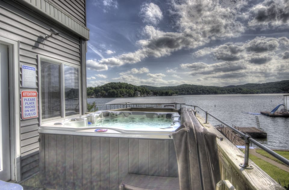 Hot tub overlooking lake and dock.