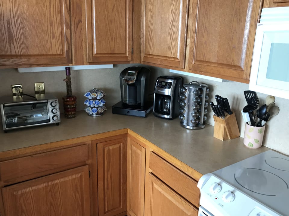 The kitchen is stocked with K-cups and spices.
