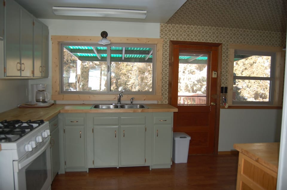 Kitchen looking out to back deck and creek