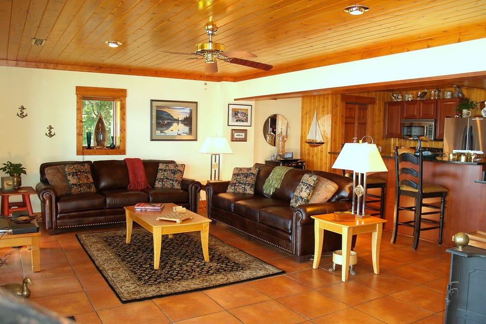 Spacious Living Room with Full Lake View and Large Slider onto the Stone Patio. 