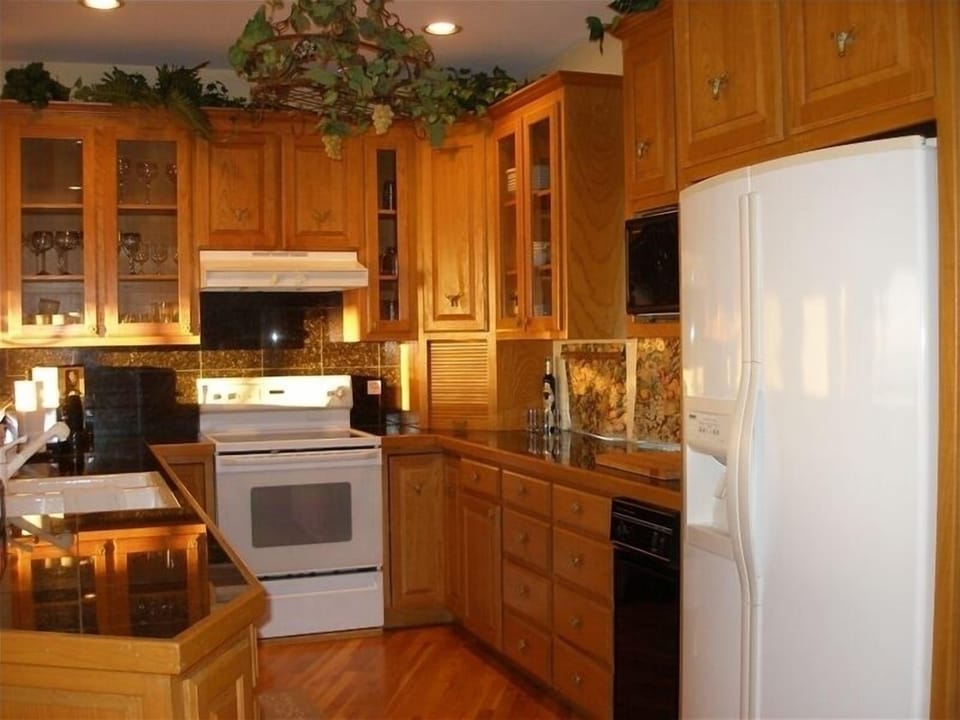 Well appointed kitchen looks out to open living area and onto covered deck. 