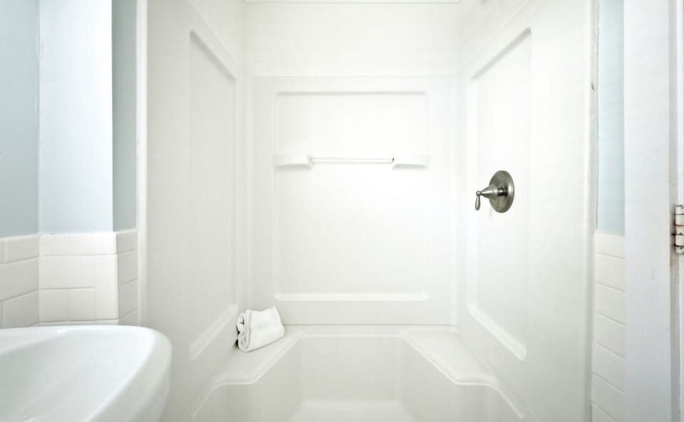 Tub and shower combination with fresh towels.