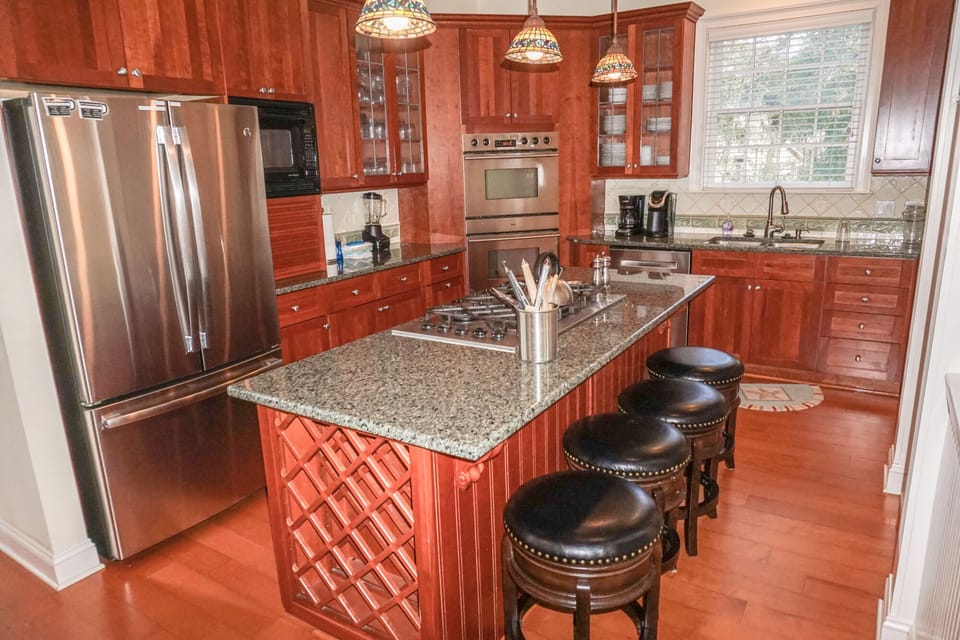 Kitchen with double oven, air fryer, microwave, gas stove top