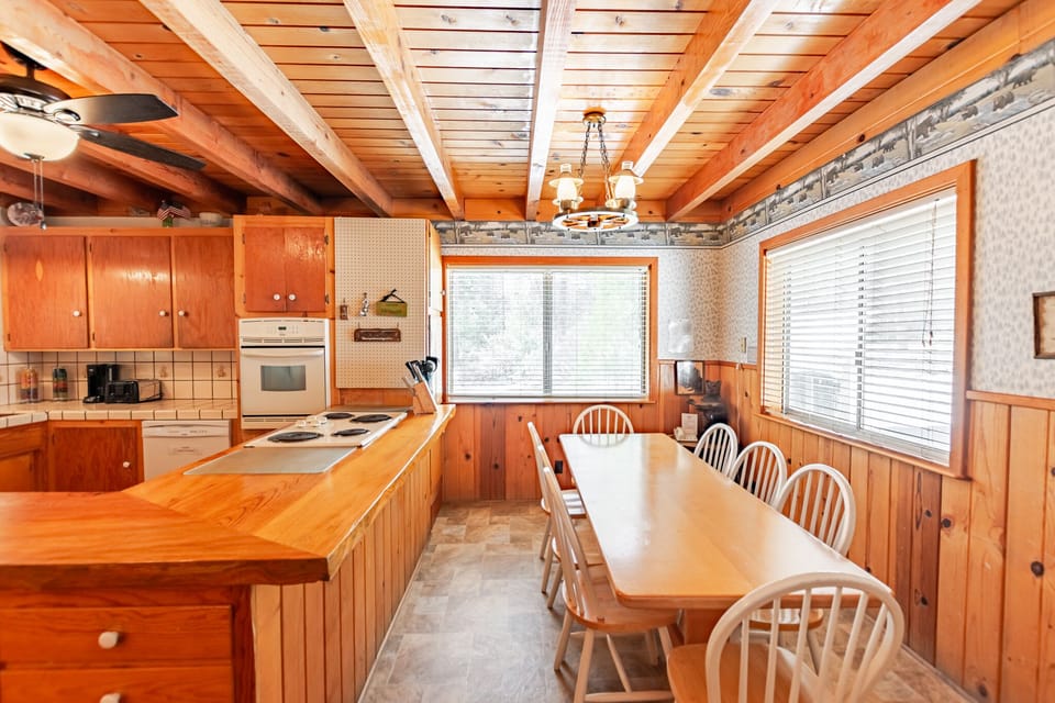Kitchen with dishwasher and microwave + dining area with seating for 8.