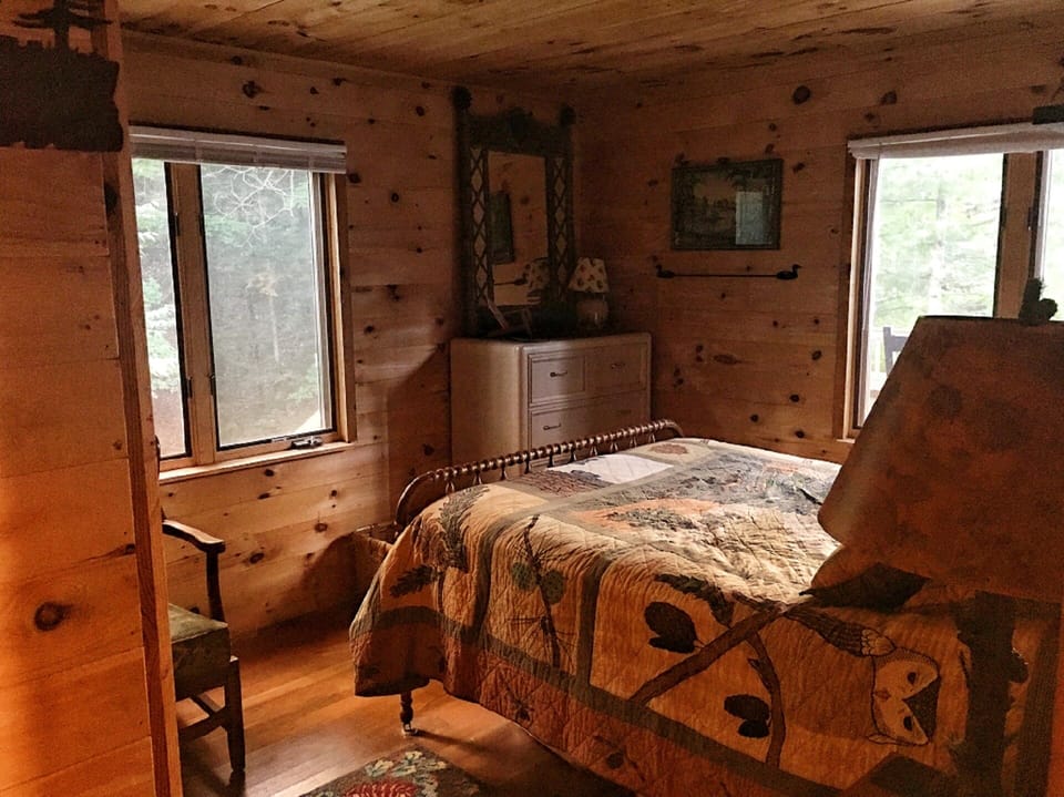 The Pine Room has a double bed, a pine woods view, and a view of the lake,