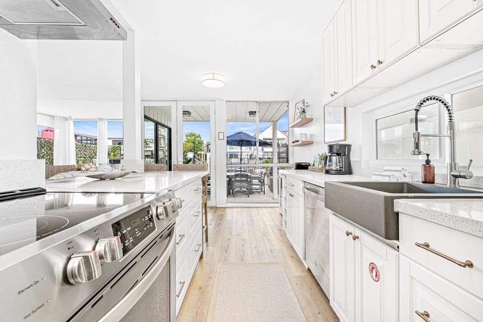The kitchen comes stocked with dishes, utensils, cookware, bakeware, and all major and small appliances.
                