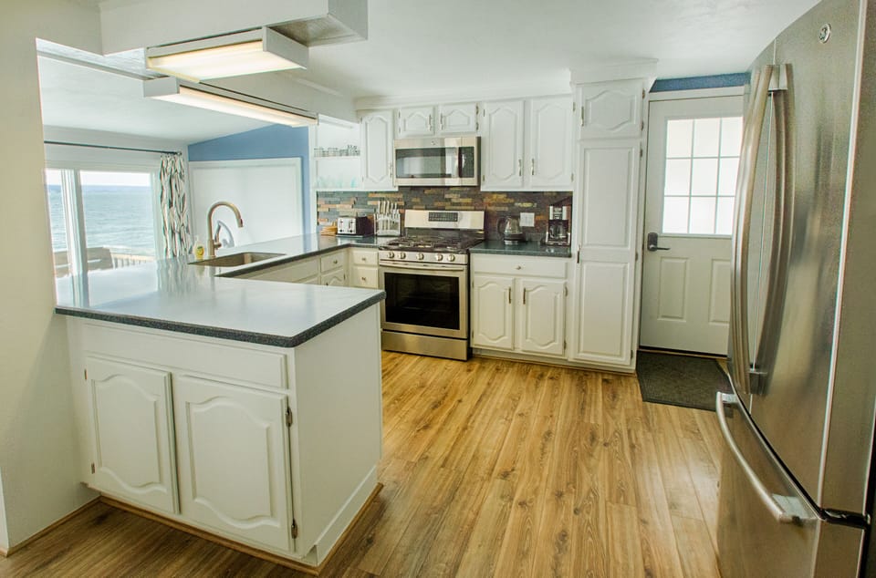 Clean, crisp, well-appointed kitchen with fantastic lake views
