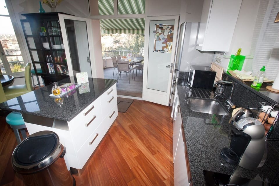Fully equipped stylish kitchen, opens onto outdoor deck