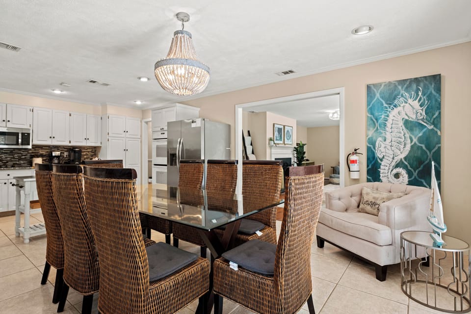 Dining area with seating for 8 and door leading to backyard