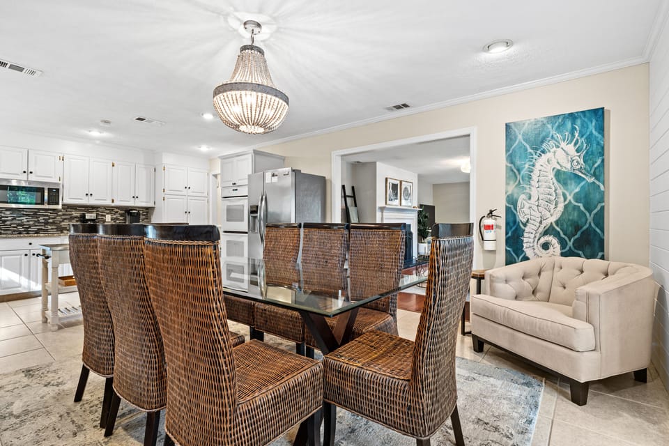 Dining area with seating for 8 and door leading to backyard