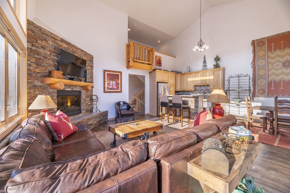 Living room with fireplace, Queen fold-out, flat screen TV, & private deck.