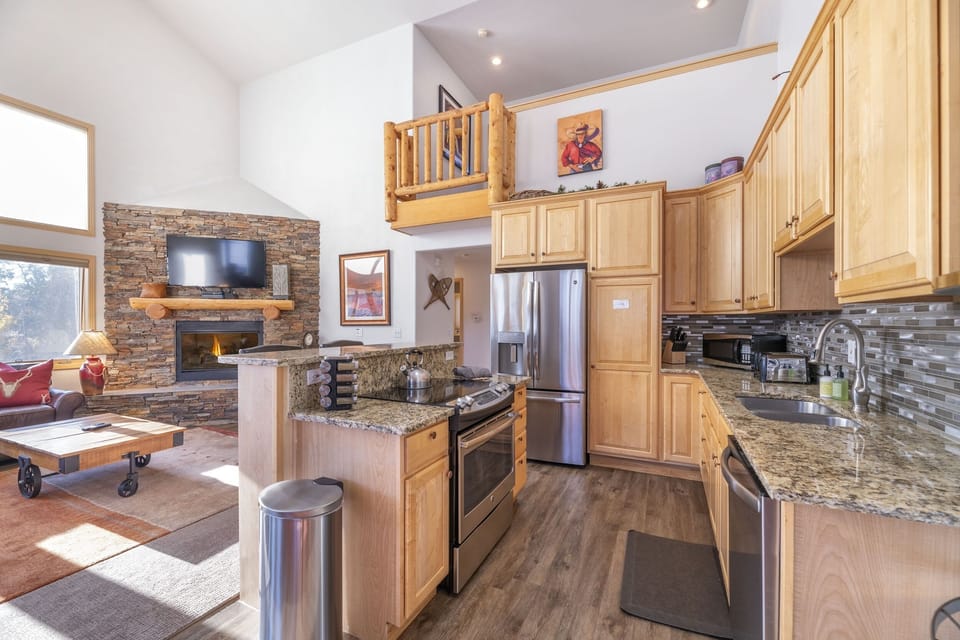 Updated kitchen with granite counters and stainless steel appliances.