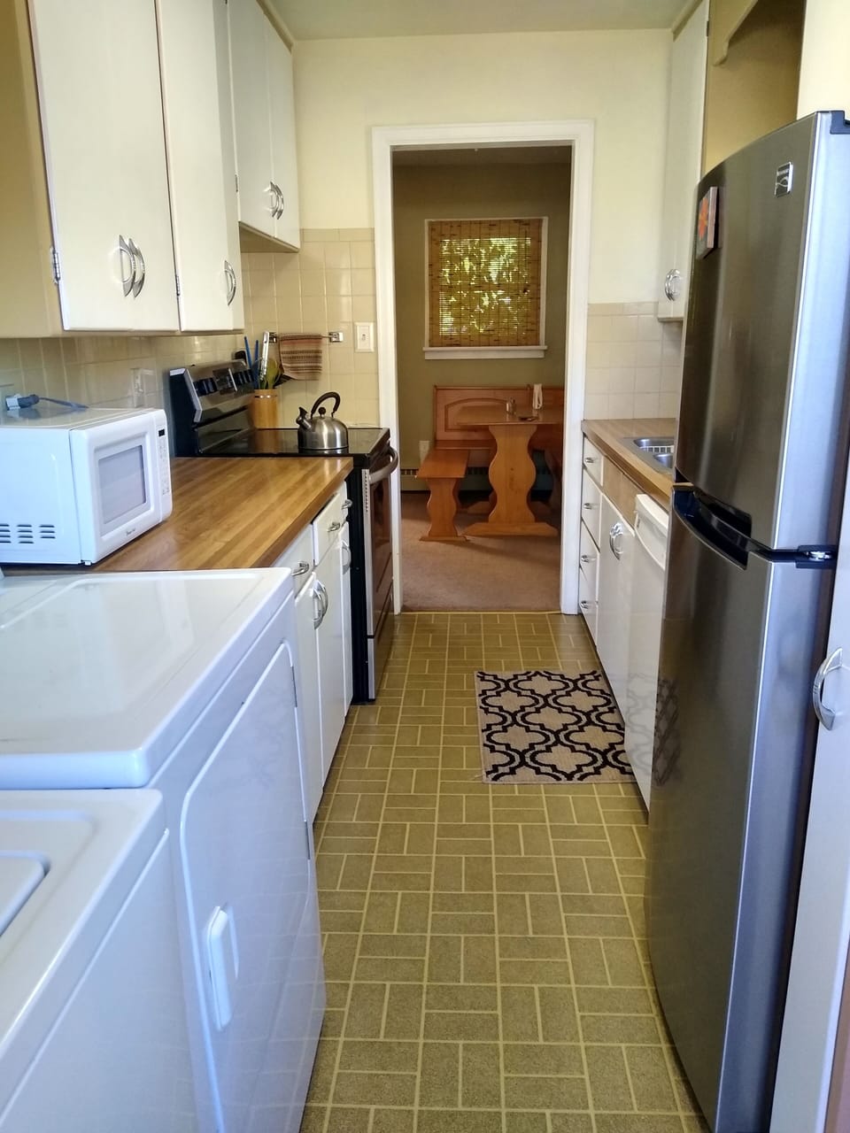 kitchen with stove fridge, dishwasher and microwave, washer and dryer.