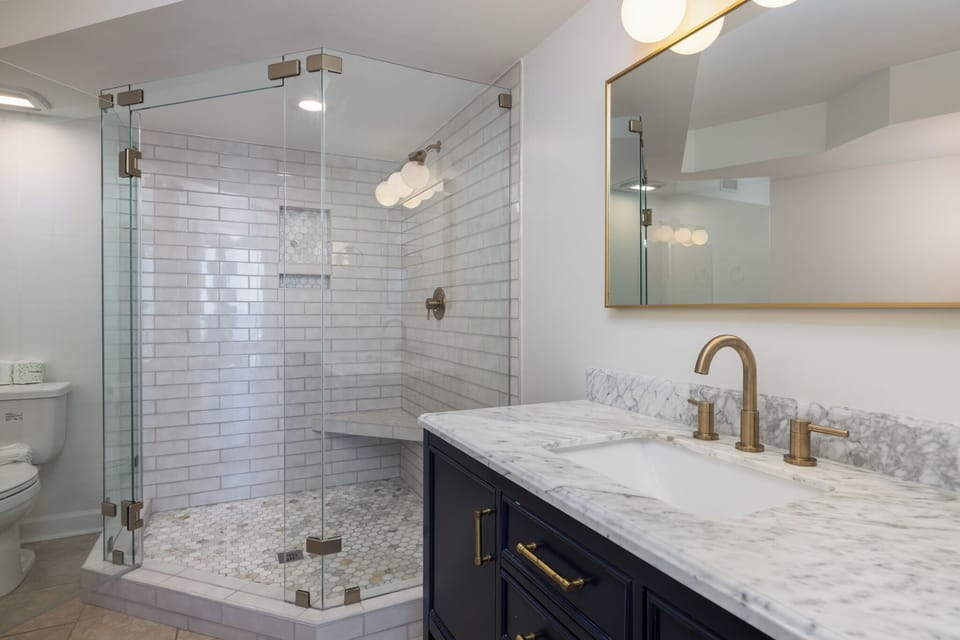 Your primary en suite bathroom has been beautifully renovated with a glass walk-in shower and dual vanity