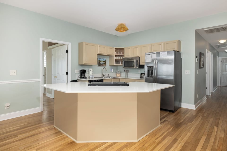 A bright and open kitchen features ample counter space and modern appliances