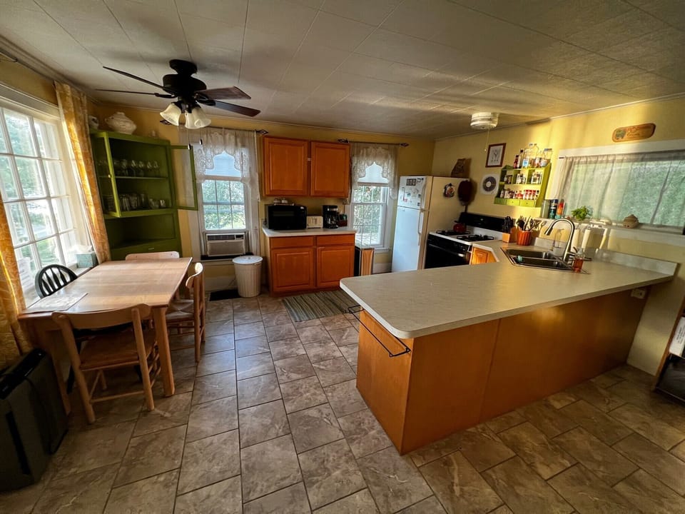 Our well-equipped and recently updated kitchen has windows on three sides. 