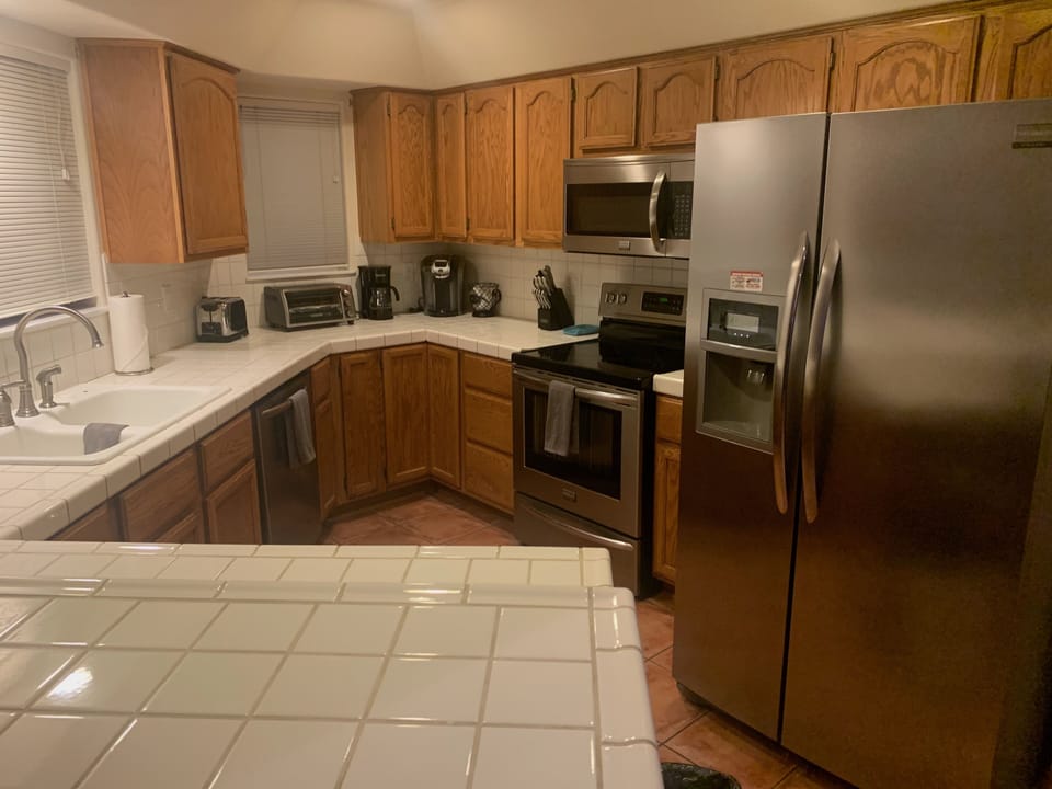 Stainless steel appliances; ice maker and water dispenser in refrigerator
