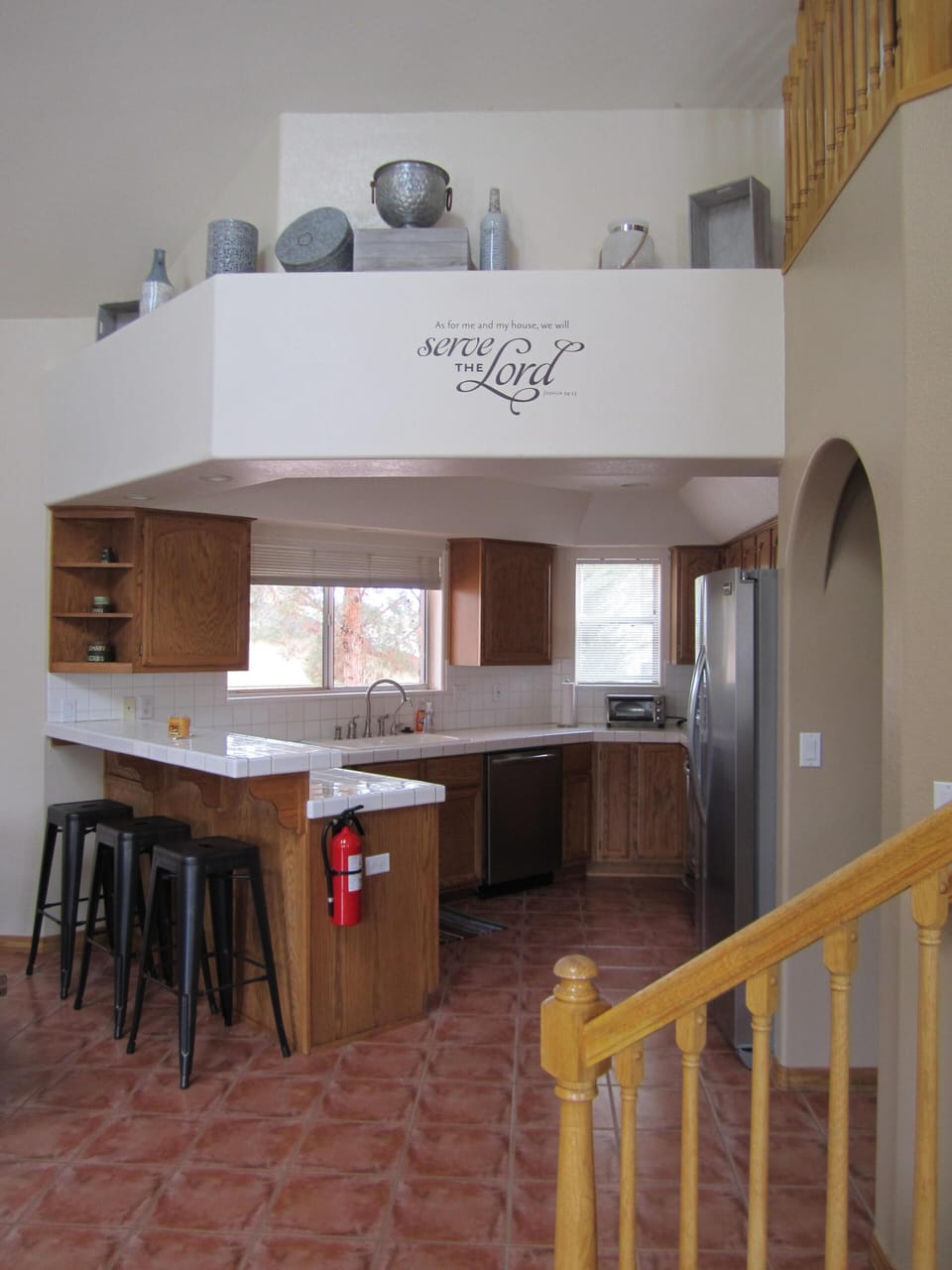Brand new kitchen appliances and seating at the bar.