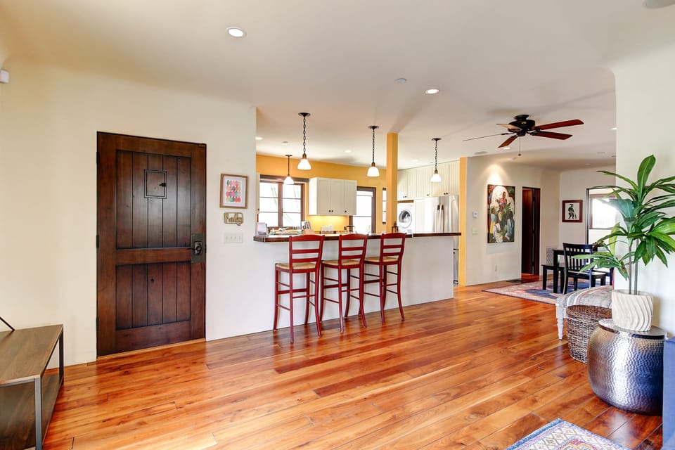 Gorgeous wood floors and professionally interior decorated this property offers a nice breakfast bar area.