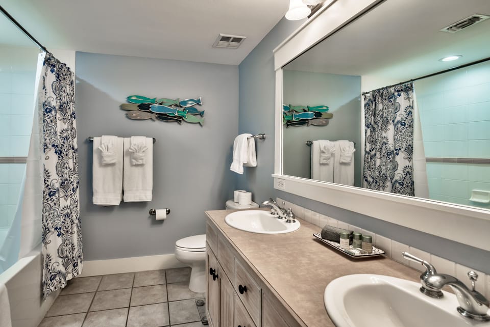 Hall (Master) bath with double sinks and tub/shower combination.