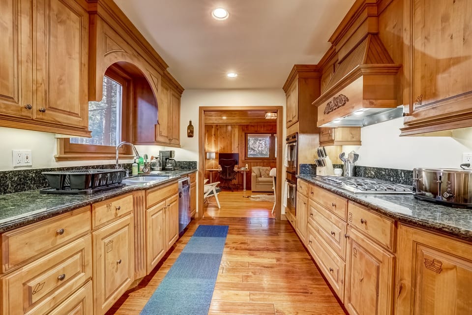The kitchen is a chef's dream, with oversized fridge, double ovens, countertops