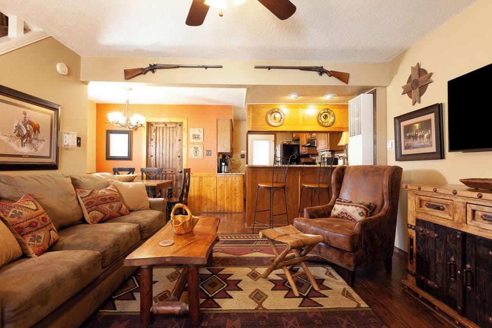Unwind in this charming Western-themed retreat with rustic furnishings, cozy seating, and a fully-equipped kitchen ready for your mountain getaway.
