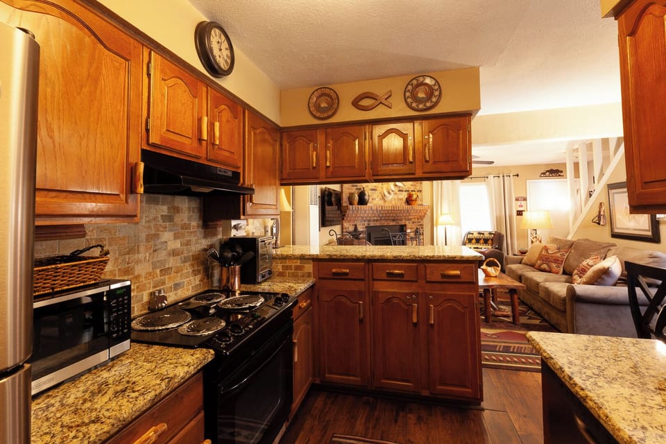 Prepare your favorite meals in this fully equipped kitchen with gleaming granite countertops, warm wood cabinetry, and all the modern appliances you need for a comfortable stay.